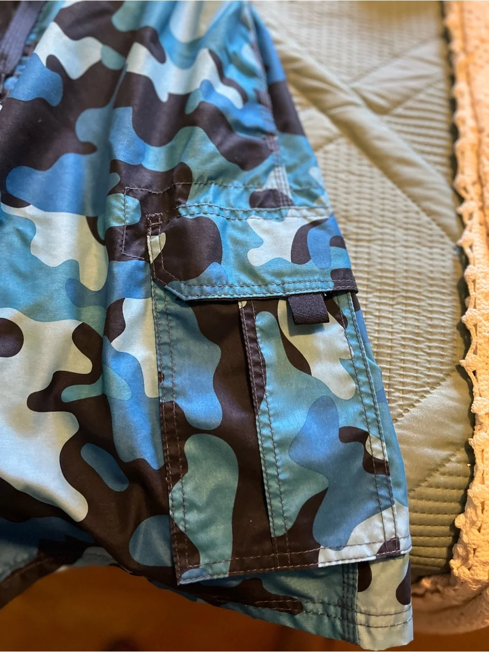 Pair of Kanu Surf Men's Blue Camo & Black Floral Swim Trunks